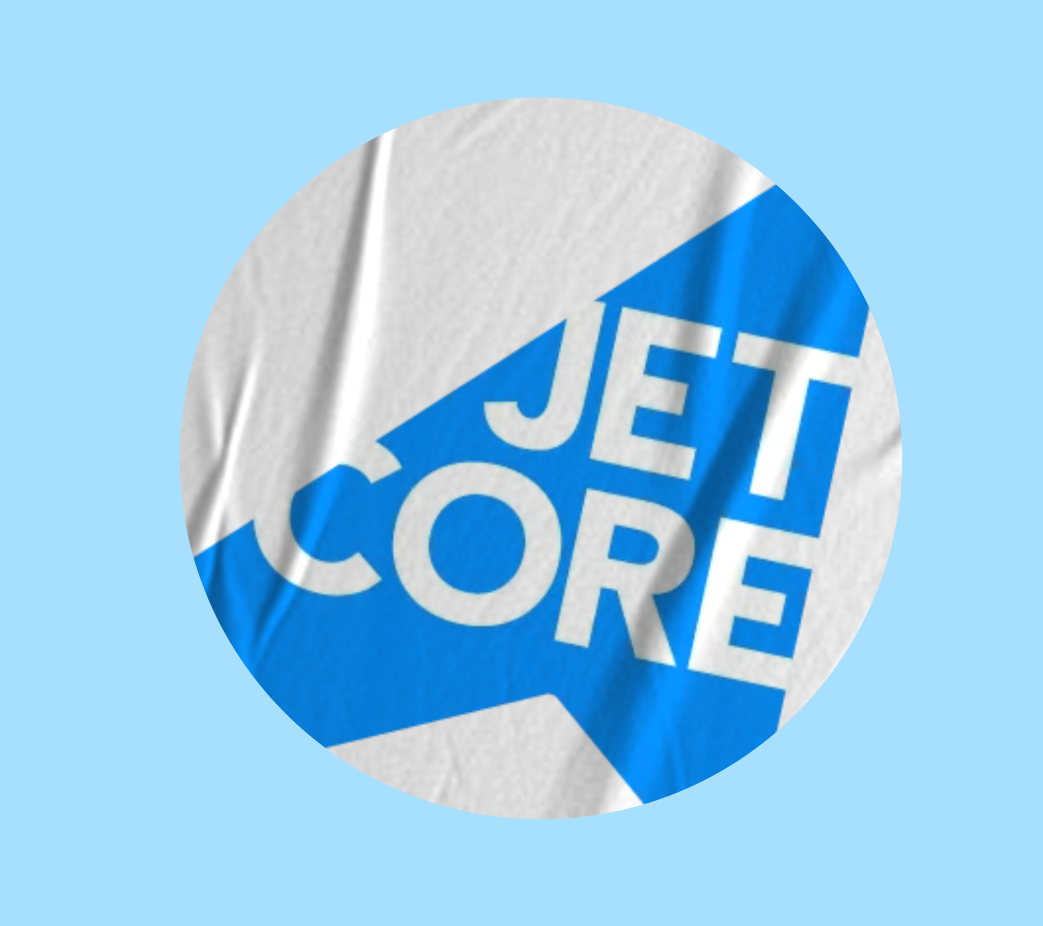 Concept application mockup: a circular crop of fabric showing the Jetcore lettering printed across a blue diagonal band on a white garment.