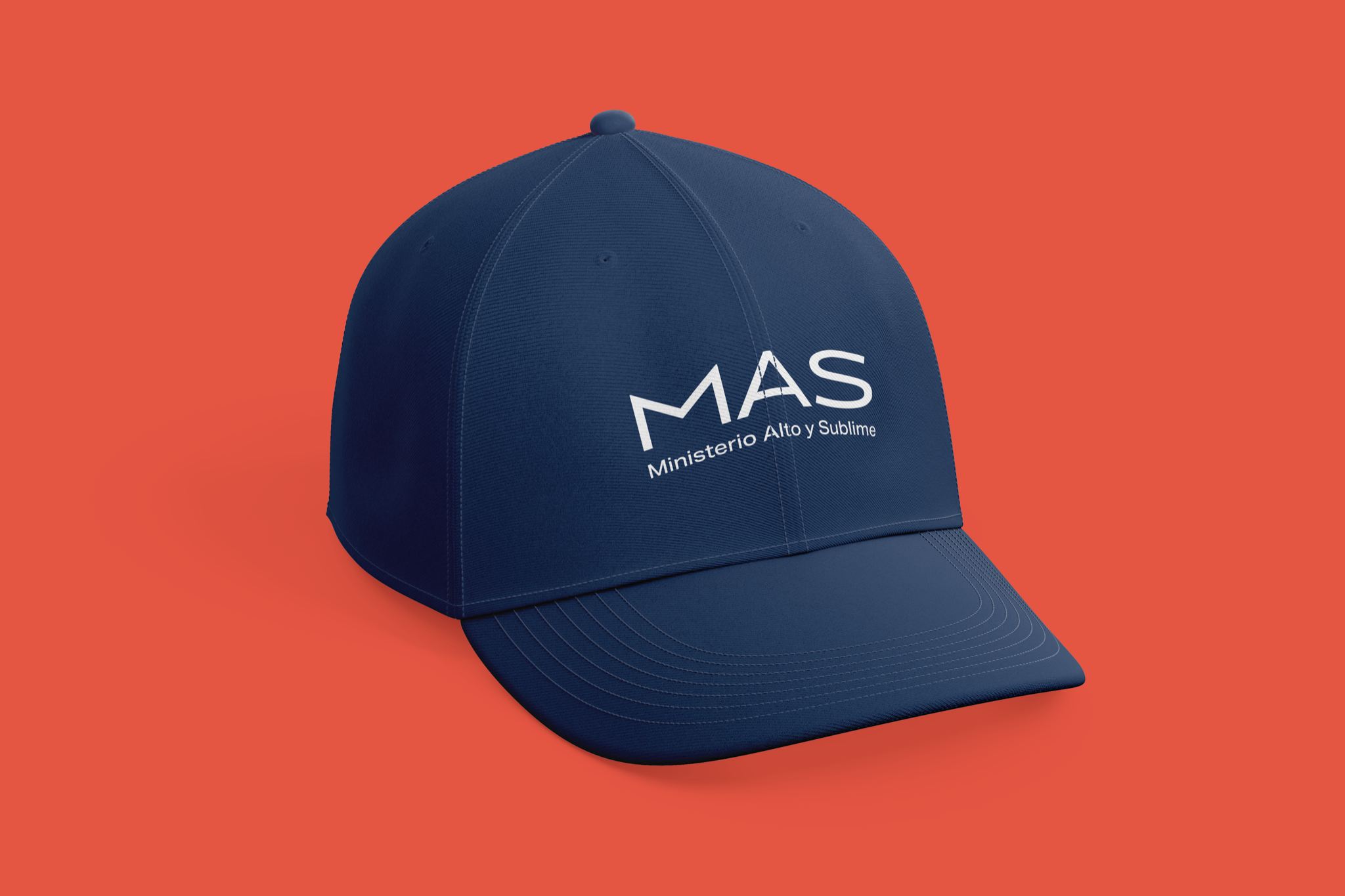 Brand application mockup: a navy baseball cap with the white MAS lockup and “Ministerio Alto y Sublime” descriptor, on an orange background.