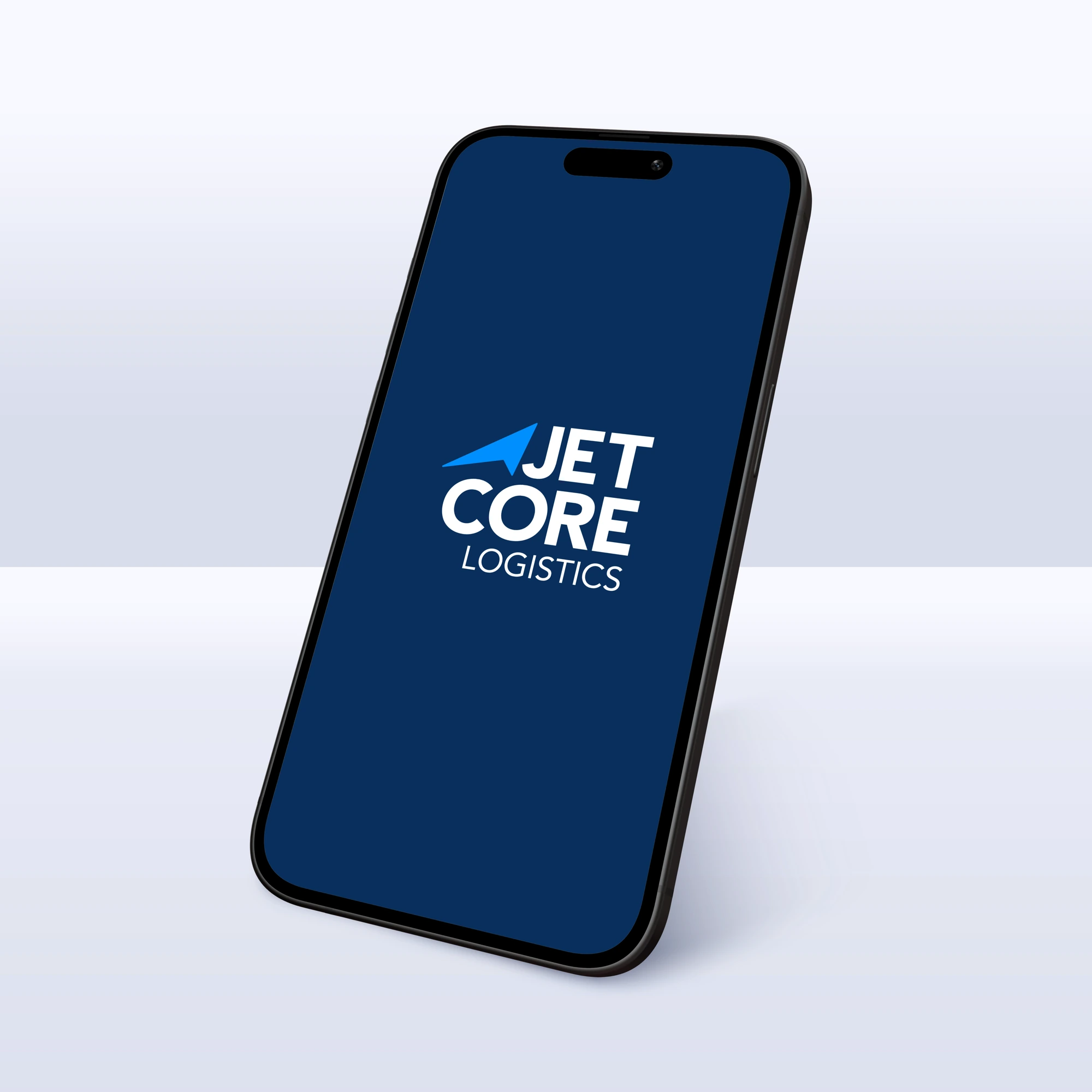 Conceptual application mockup: a tilted smartphone on a light background showing a navy splash screen with the white stacked Jetcore Logistics lockup and blue directional symbol.