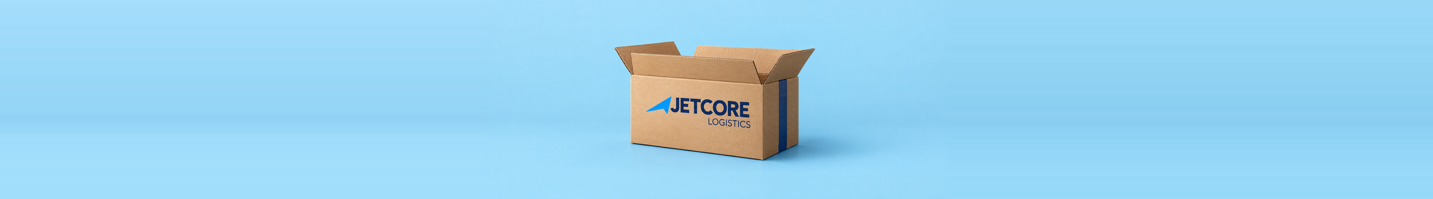 Conceptual application mockup: an open Jetcore-branded cardboard box centered on a wide pale blue background.